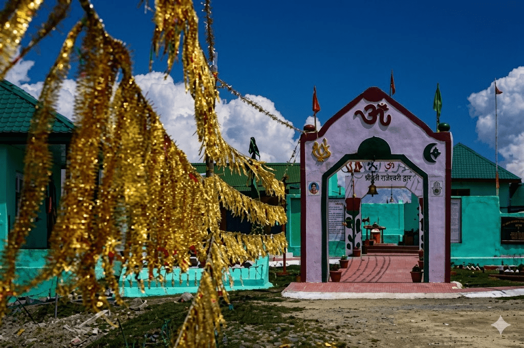 A pink and green entrance archway under a bright blue sky, with golden tinsel decorations in the foreground.