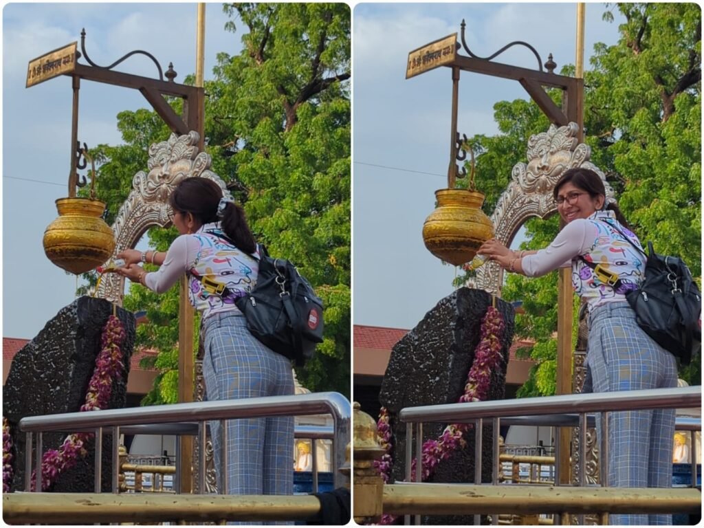 Transforming Travels tour leader and company founder Chandni Agarwal offering mustard oil during the sacred abhishek ritual at Shani Shingnapur Temple, Maharashtra.