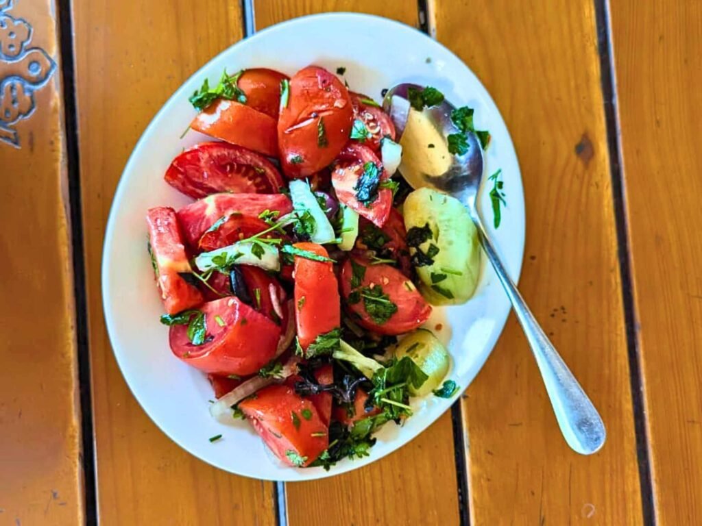 Tomato and cucumber salad with walnut dressing in Georgian cuisine