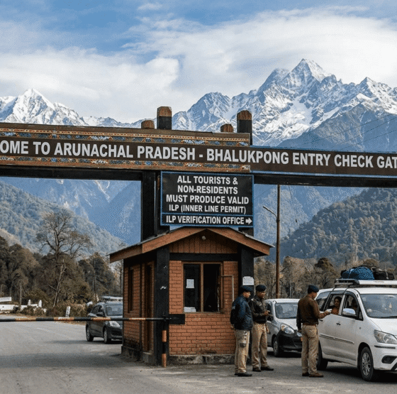 Travellers entering Arunachal Pradesh through an Inner Line Permit checkpoint on a mountain road