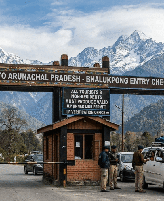 Travellers entering Arunachal Pradesh through an Inner Line Permit checkpoint on a mountain road